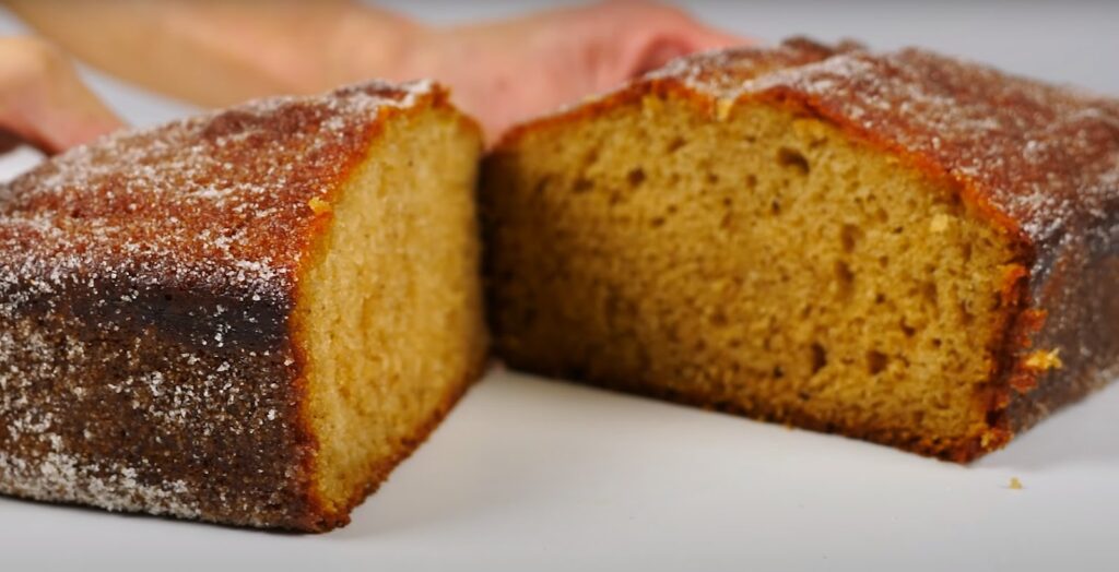 a loaf of apple cider donut bread cut in half