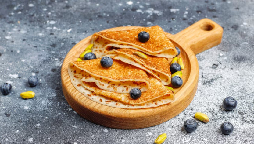 pancakes with blueberry and wooden desk on marble gray table