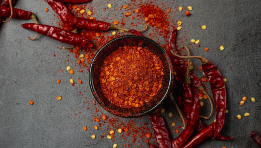 chili and chili seed in a bowl on gray table